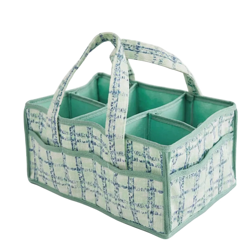 Green and white plaid baby diaper caddy with multiple compartments and handles.