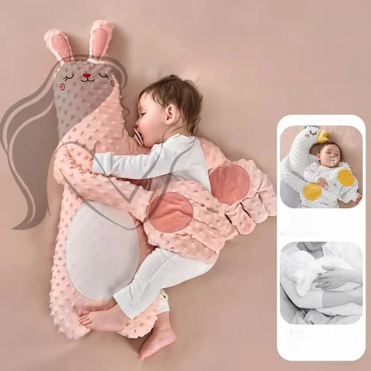 Baby sleeping peacefully, hugging a pink bunny electric soothing pillow with remote control.