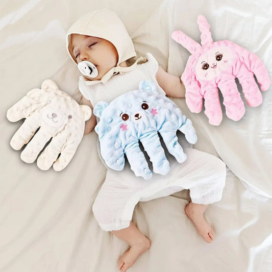 Sleeping baby with pacifier, surrounded by three soft, hand-shaped calming pillows: white bear, blue bear, and pink bunny.