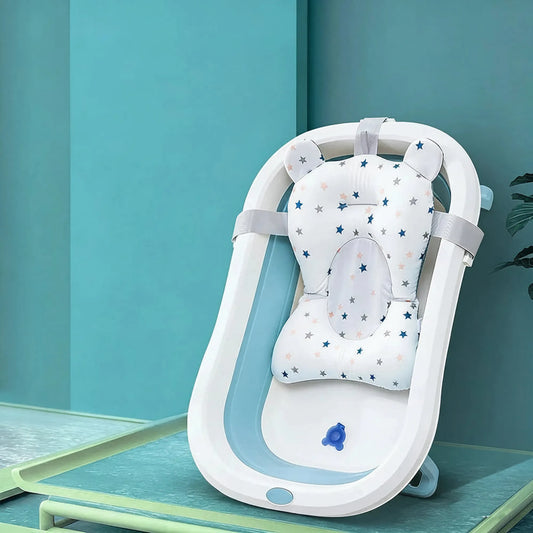 White and blue foldable baby bathtub with a soft, star-patterned bath support cushion.