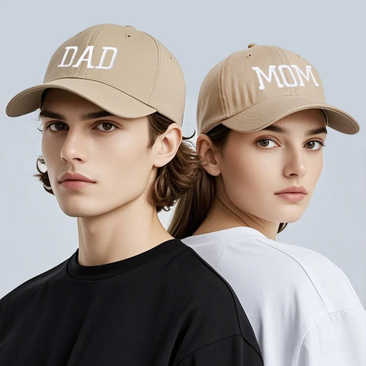 Adjustable beige cotton baseball caps for "DAD" and "MOM" with white embroidery.