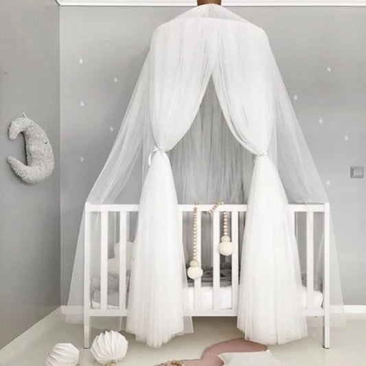 White polyester tulle canopy with star decorations over a baby crib in a grey room.