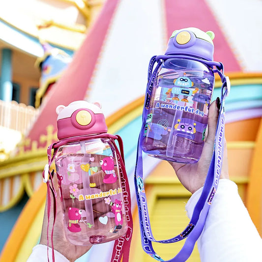 Two 650ml kids' water bottles with straws, handles, and cartoon designs; one pink with flowers, one purple with robots.