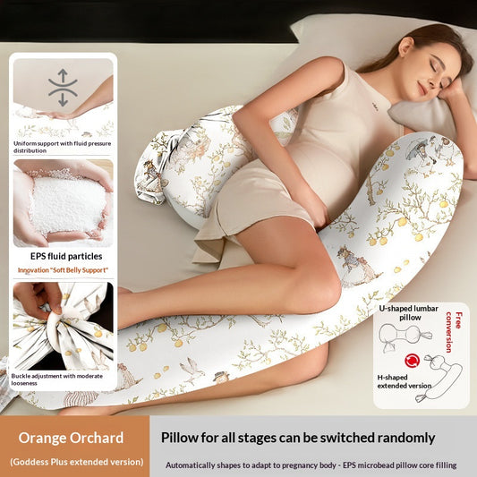 White U-shaped pregnancy pillow with orange orchard pattern, supporting a sleeping pregnant woman.