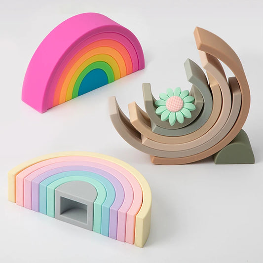 Colorful silicone rainbow stacking toys for babies, including a flower teether.