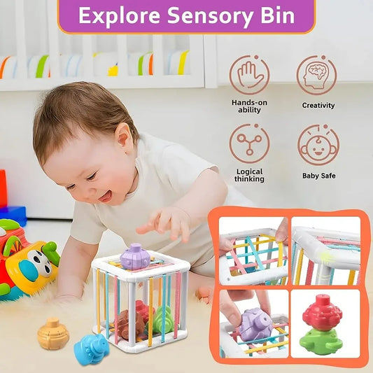 Baby playing with a white Montessori sensory bin featuring colorful elastic bands and various shaped blocks.