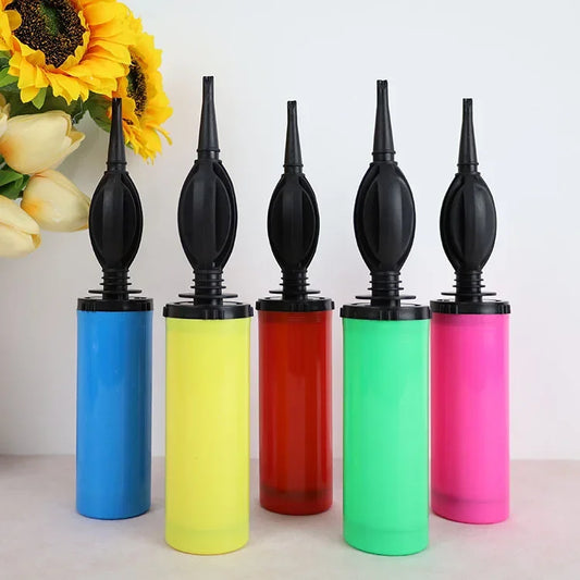 Compact manual balloon pumps in blue, yellow, red, green, and pink with black nozzles.