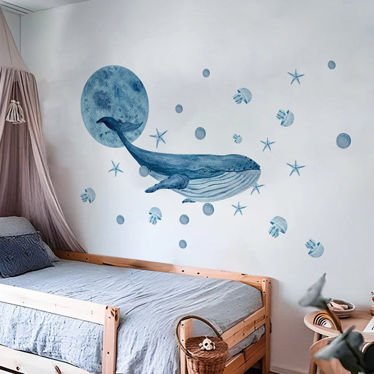 Watercolor blue whale wall decals with jellyfish and stars for a child's room.