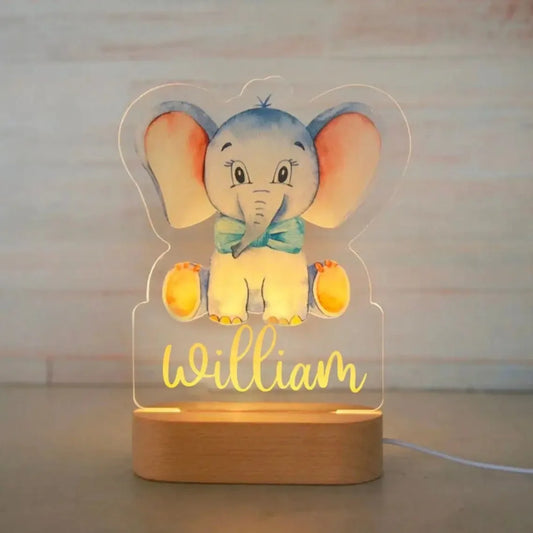 Personalized LED night light with a cute elephant design on acrylic and a wooden base, featuring the name "William" in yellow.
