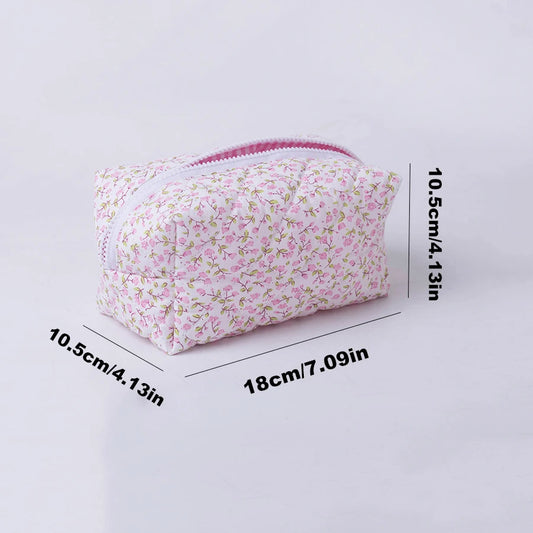 Quilted floral makeup bag with pink zipper, 18cm x 10.5cm, for travel and daily use.