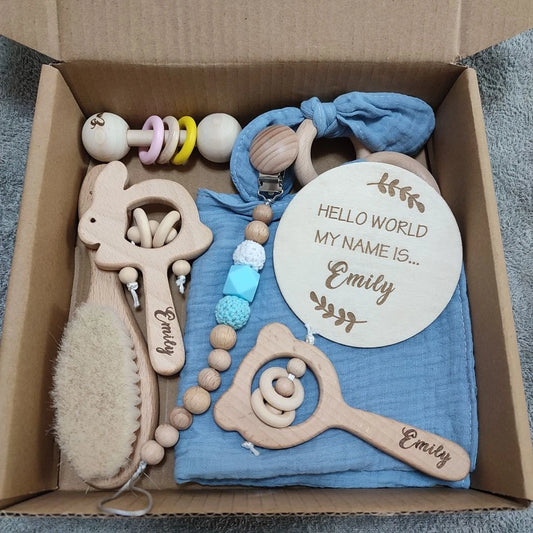 Personalized 8-piece natural wood baby gift set with rattles, brush, pacifier clip, and "Hello World" sign.