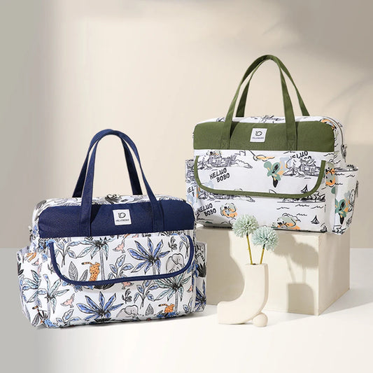 Two waterproof Oxford fabric diaper bags with nature prints; one with blue accents, the other with green.