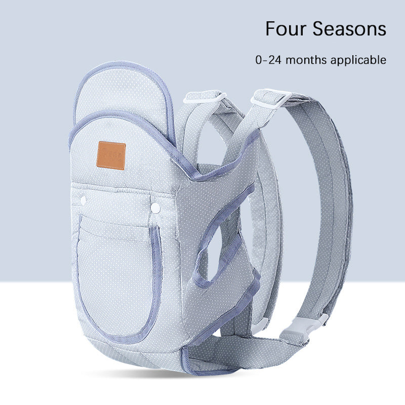 Light gray ergonomic baby carrier with white polka dots and blue trim, suitable for 0-24 months.