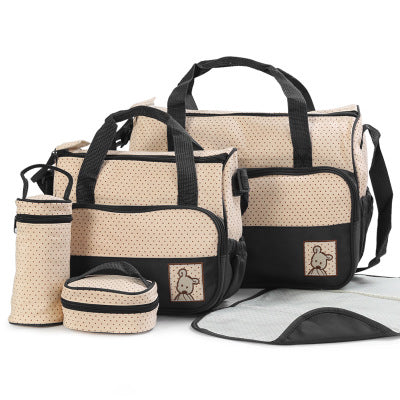 Beige and black 5-piece diaper bag set with polka dots, including two bags, bottle holder, and changing pad.