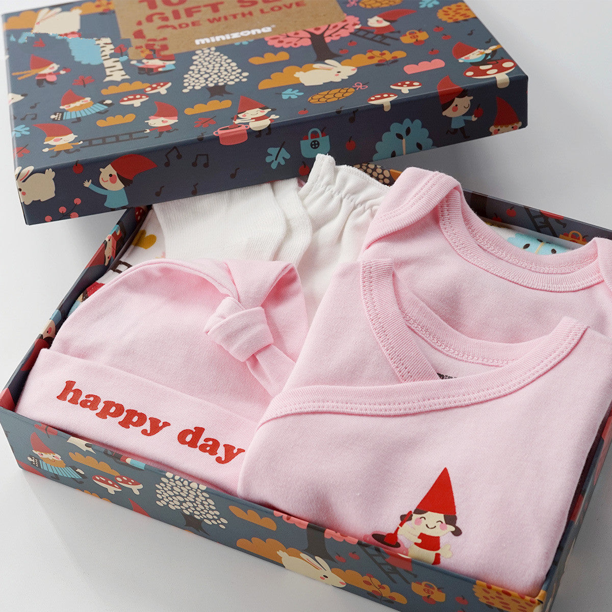 Pink 10-piece cotton baby gift set with gnome print box, includes bodysuit, hat, and pants.