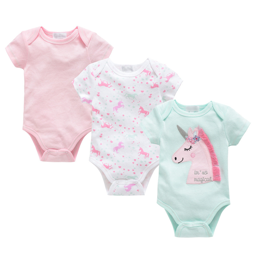 Three soft cotton baby bodysuits: pink, white with unicorn print, and mint green with a pink unicorn.