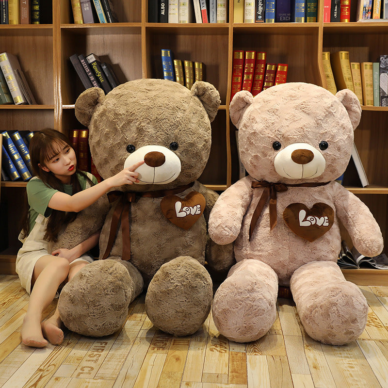 Two large, soft plush teddy bears, one brown and one pink, with "Love" hearts and bows.