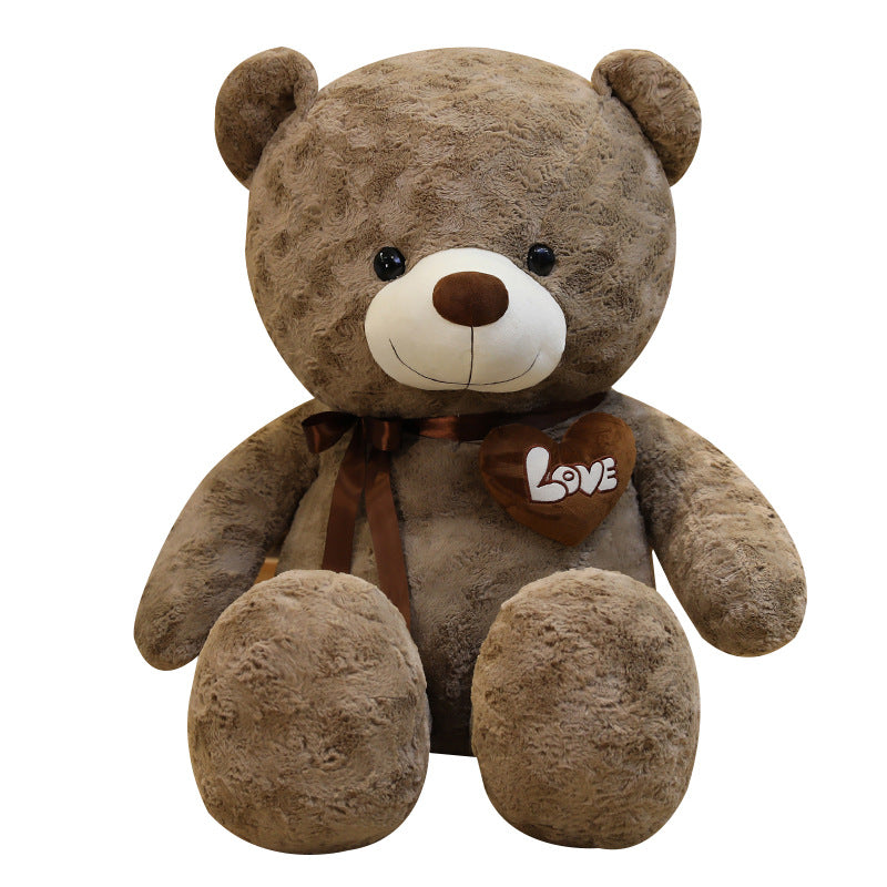 Large brown plush teddy bear with a "Love" heart and satin ribbon.