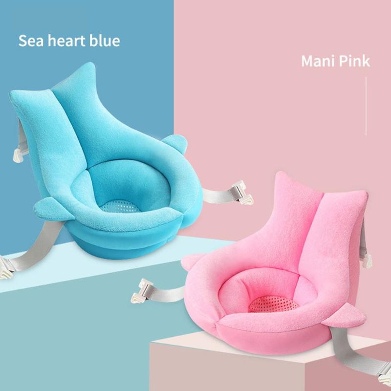 Two soft, floating baby bath cushions in blue and pink, shaped like whales with adjustable straps.