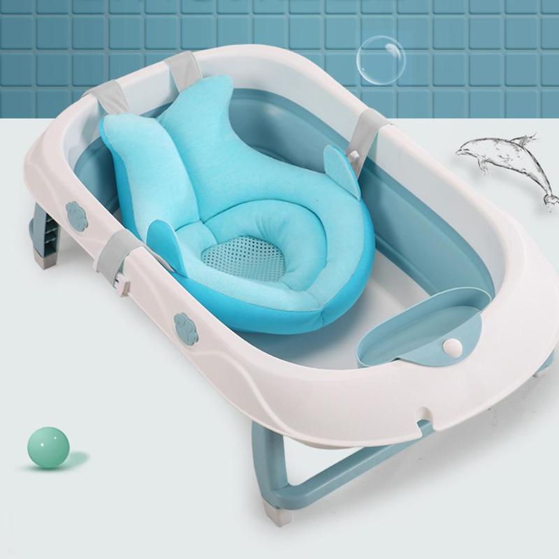 White and blue foldable baby bathtub with a soft, breathable light blue floating bath cushion.