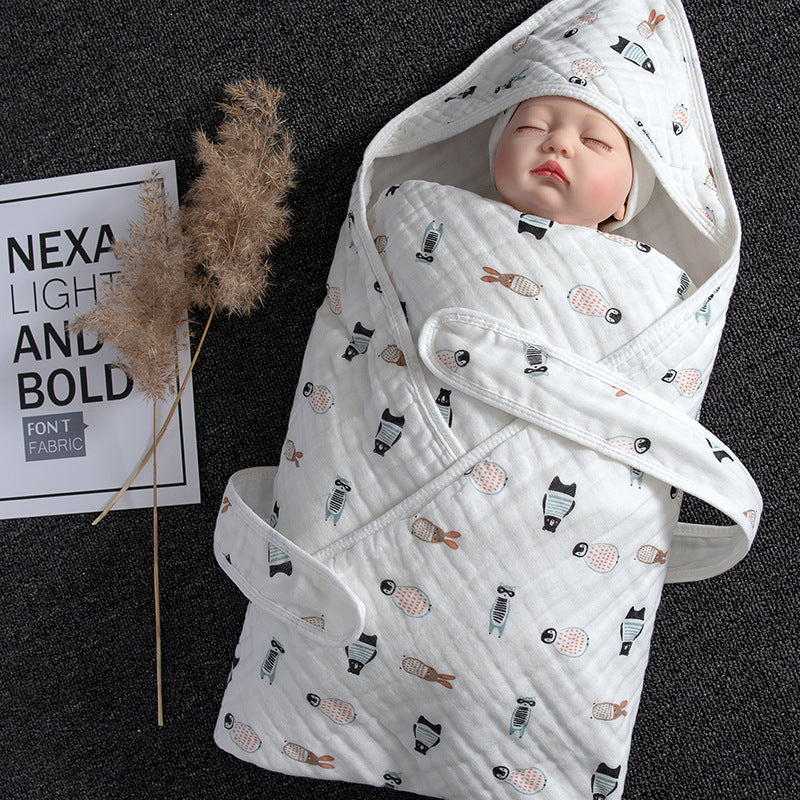 White cotton gauze baby swaddle blanket with hood, featuring a cute animal pattern and a sleeping doll.