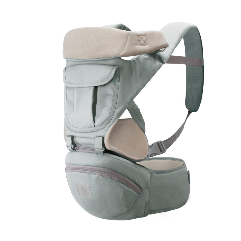 Ergonomic baby carrier with breathable light green fabric, hip seat, and storage pockets.