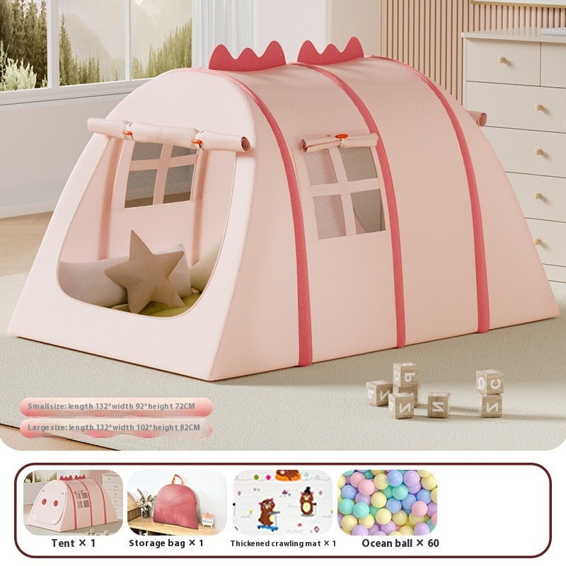 Pink fabric play tent for kids, with windows, dinosaur spikes, and a star pillow inside.