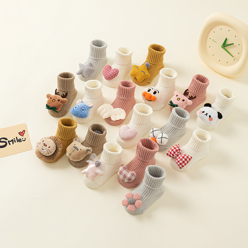 Assorted cotton baby socks with anti-slip soles and cute animal/pattern designs.