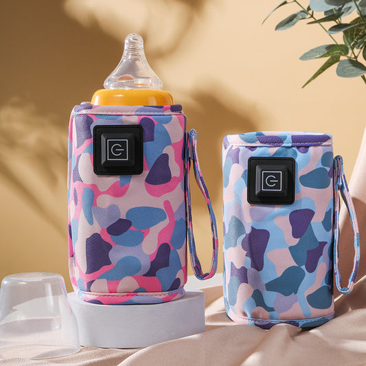 Two portable baby bottle warmers in pink, blue, and purple camouflage, one holding a bottle.