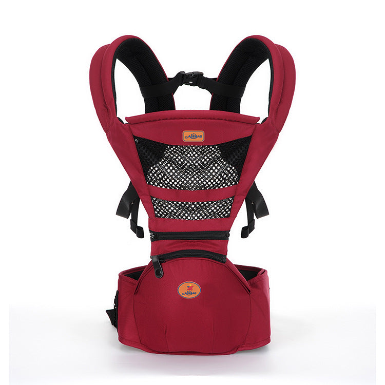 Red ergonomic baby carrier with breathable mesh, padded straps, and a hip seat.
