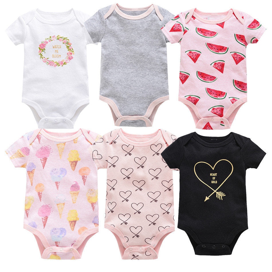 Six short-sleeve cotton baby bodysuits: white floral, grey, pink watermelon, pink ice cream, pink hearts, black "Heart of Gold".
