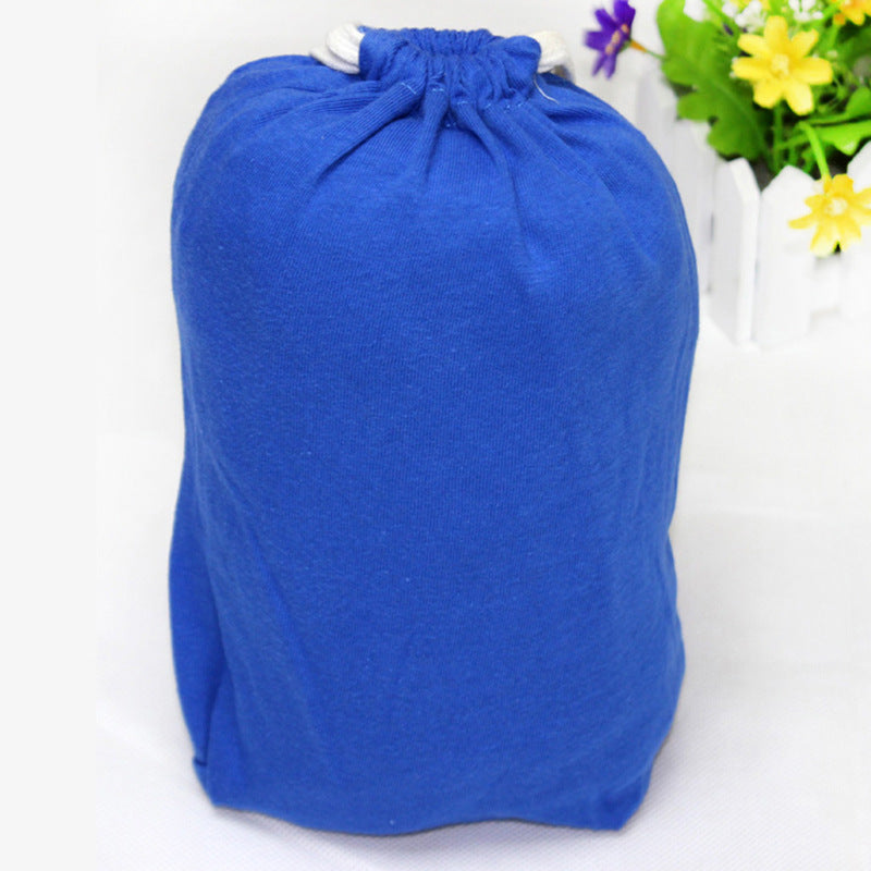 Blue cotton X-type ergonomic baby carrier, folded and stored in a matching drawstring pouch.