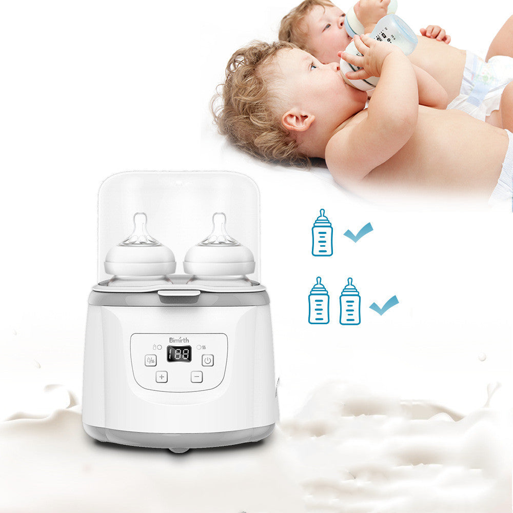 White dual baby bottle warmer with digital display, sterilizing two bottles, with babies drinking milk in the background.