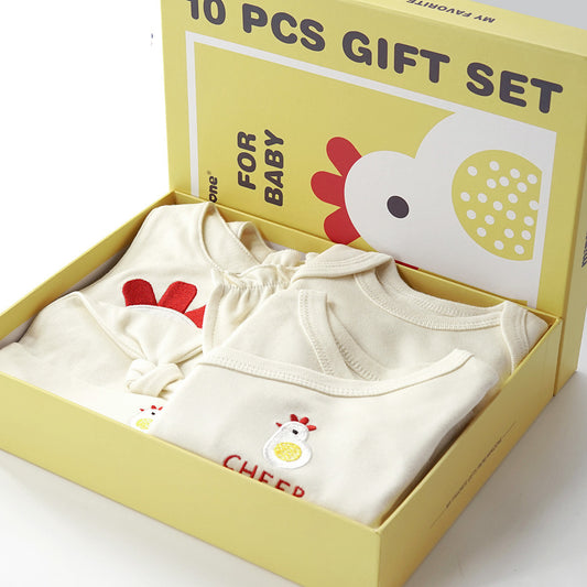 Cream 10-piece organic cotton baby gift set with chicken and chick embroidery, in a yellow box.