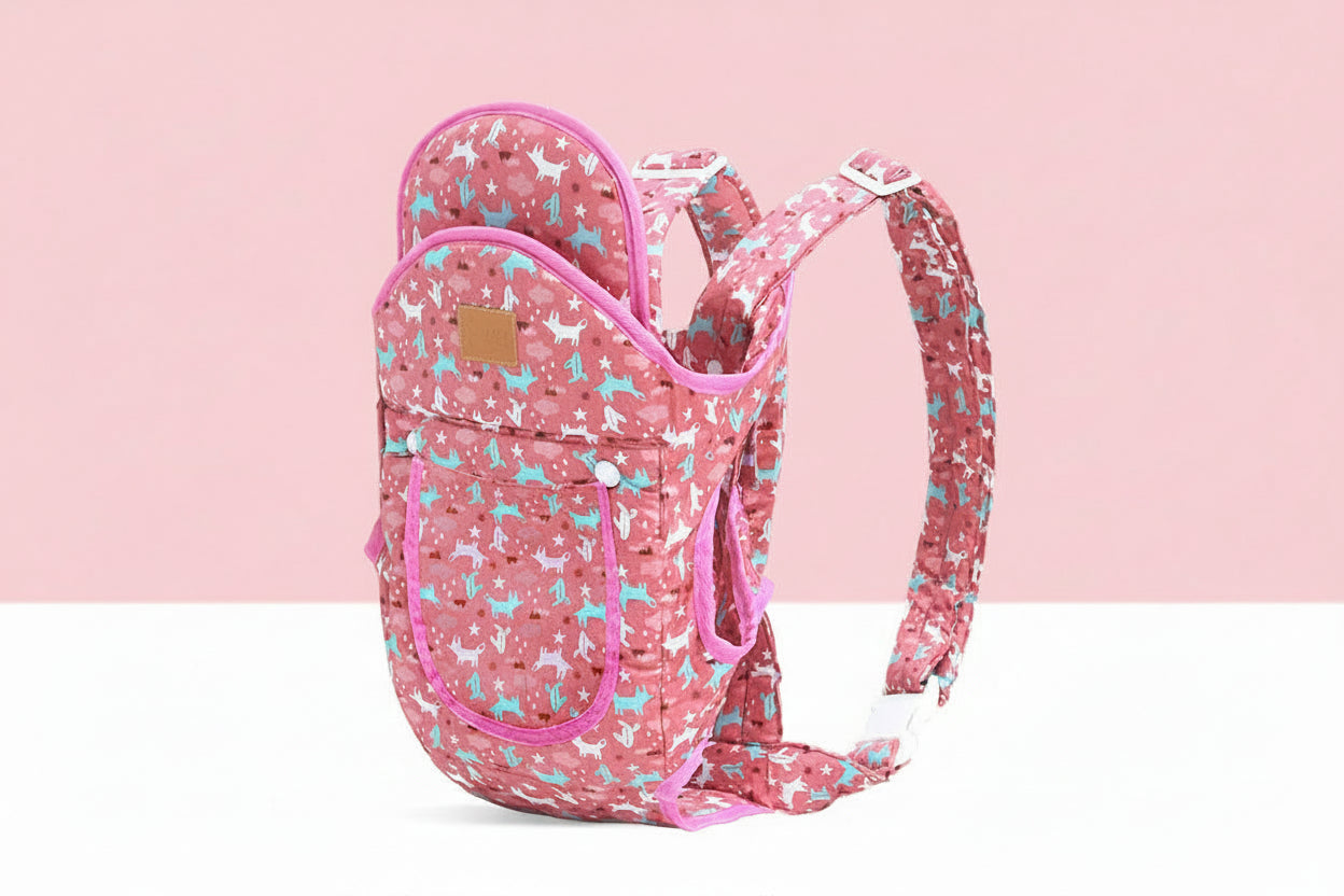 Pink ergonomic baby carrier with white and blue animal print, adjustable straps, and front pocket.