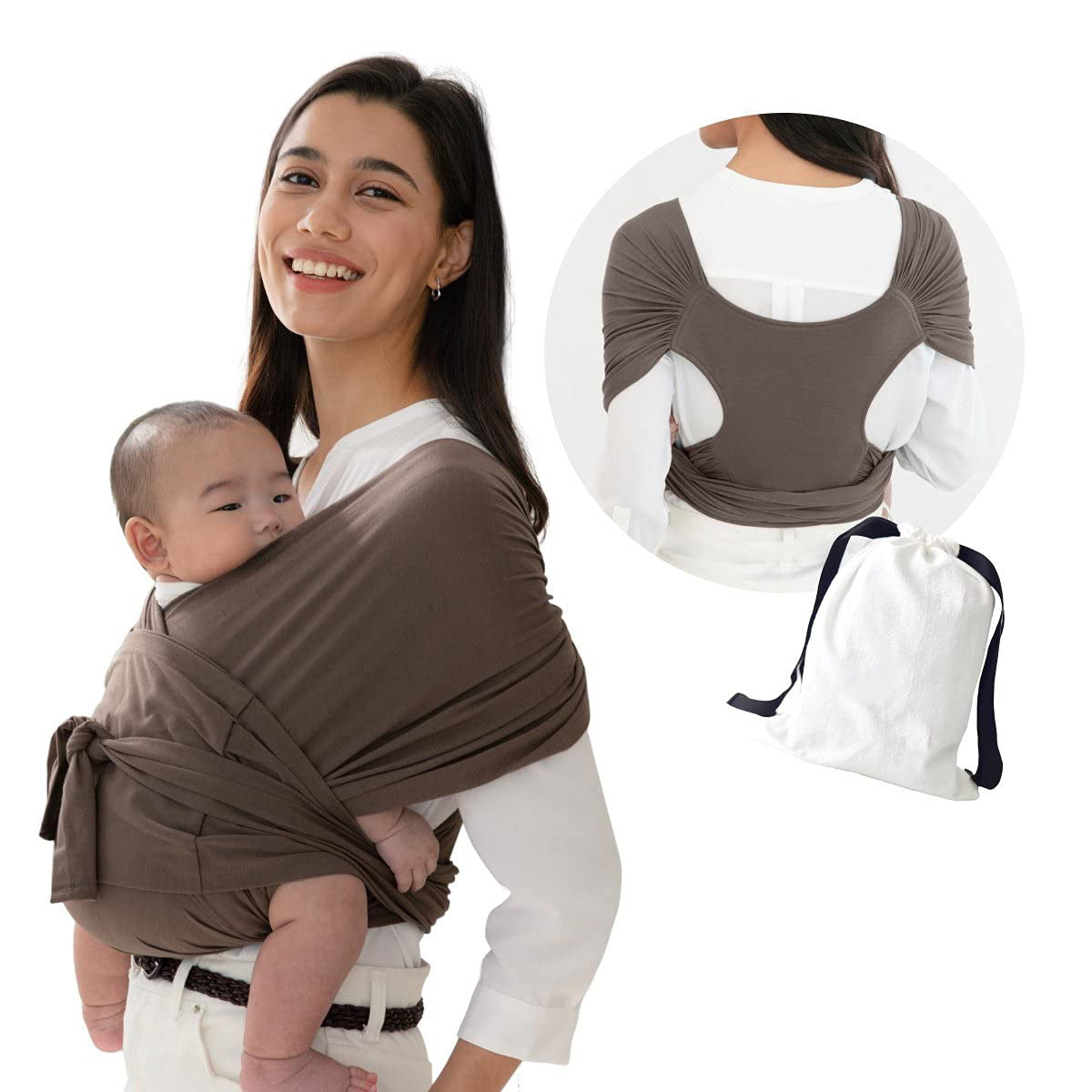 Smiling woman carrying baby in a brown X-type ergonomic cotton baby carrier, with a white storage bag.