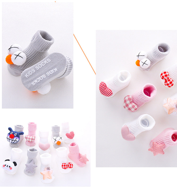 Assorted cotton baby socks with anti-slip soles, featuring cute designs like animals, stars, and bows.