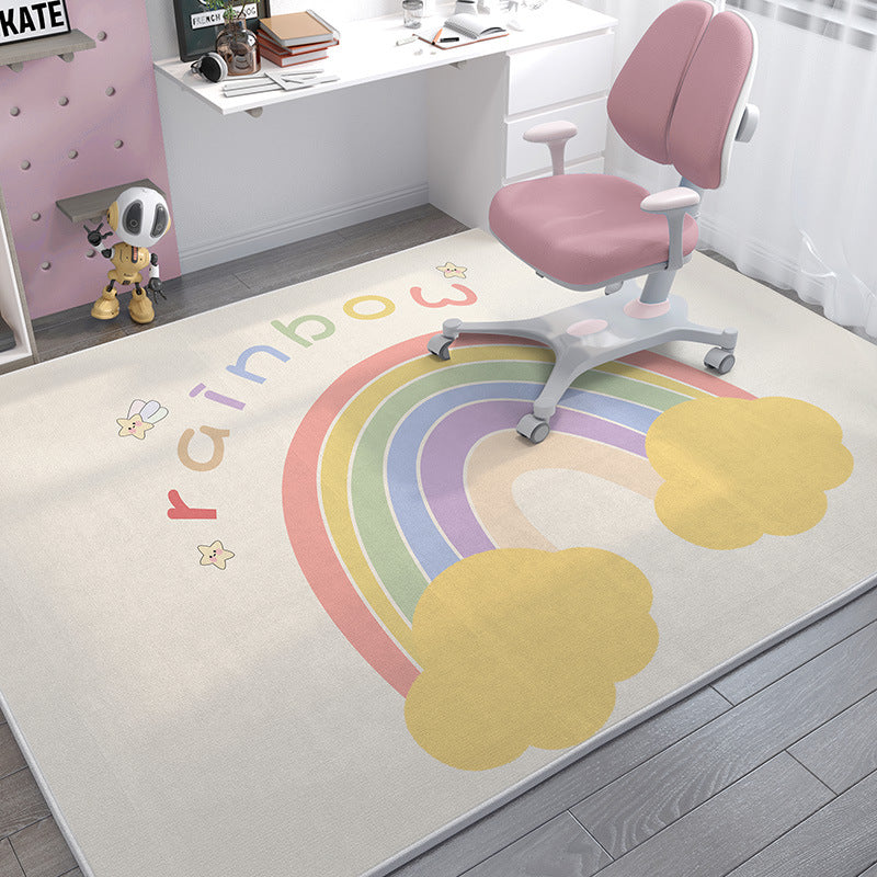 Soft crystal velvet kids' rug with a pastel rainbow and "rainbow" text, under a pink desk chair.