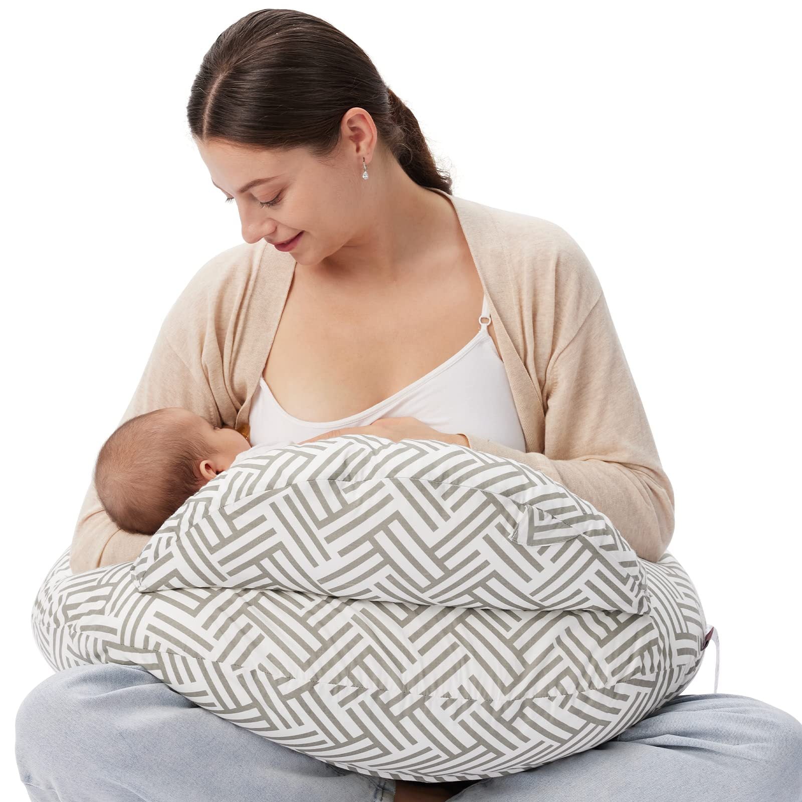 Mother breastfeeding baby using a gray and white geometric pattern nursing pillow.