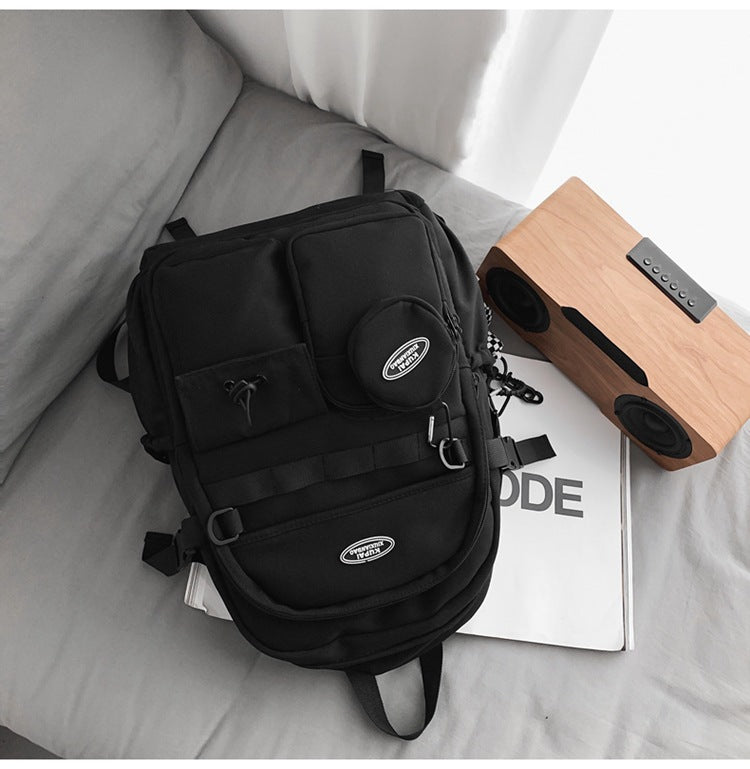 Black nylon student backpack with laptop compartment, multiple pockets, and modern design.