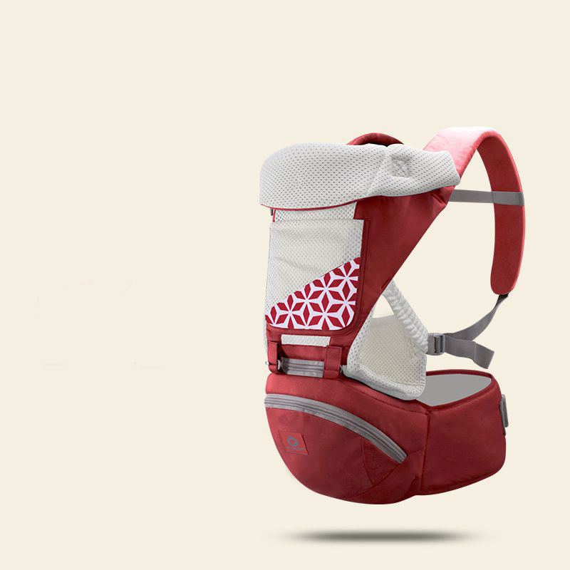 Red ergonomic baby carrier with breathable mesh, hip seat, and geometric pattern.