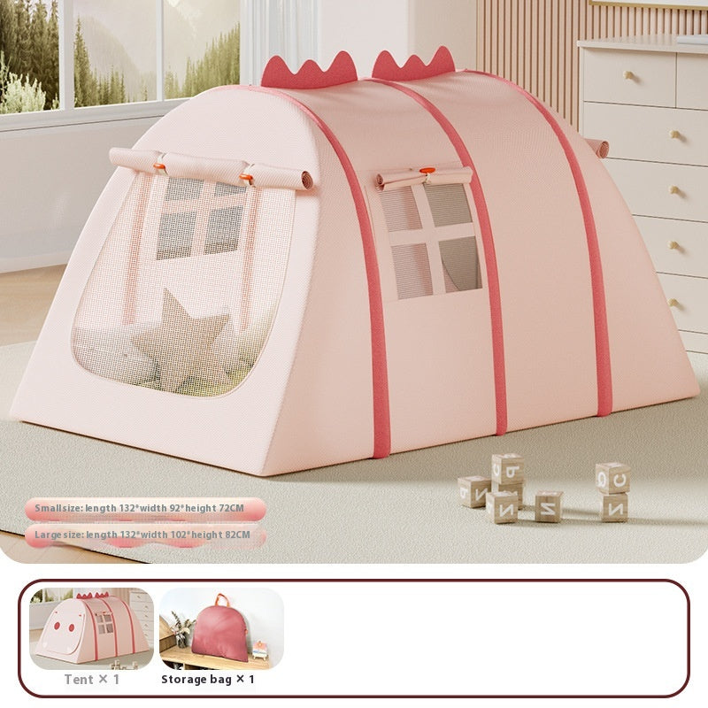 Pink fabric play tent for kids, shaped like a dinosaur with mesh windows, shown indoors.