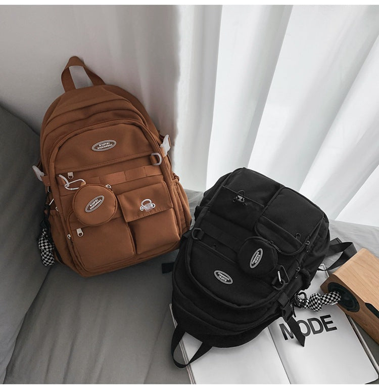 Brown and black nylon student backpacks with multiple pockets, laptop compartment, and small detachable pouch.