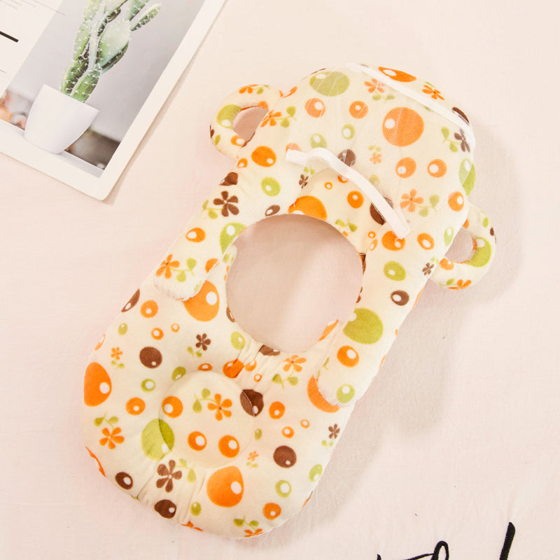 Soft velvet baby nursing and feeding pillow with colorful floral and dot pattern.