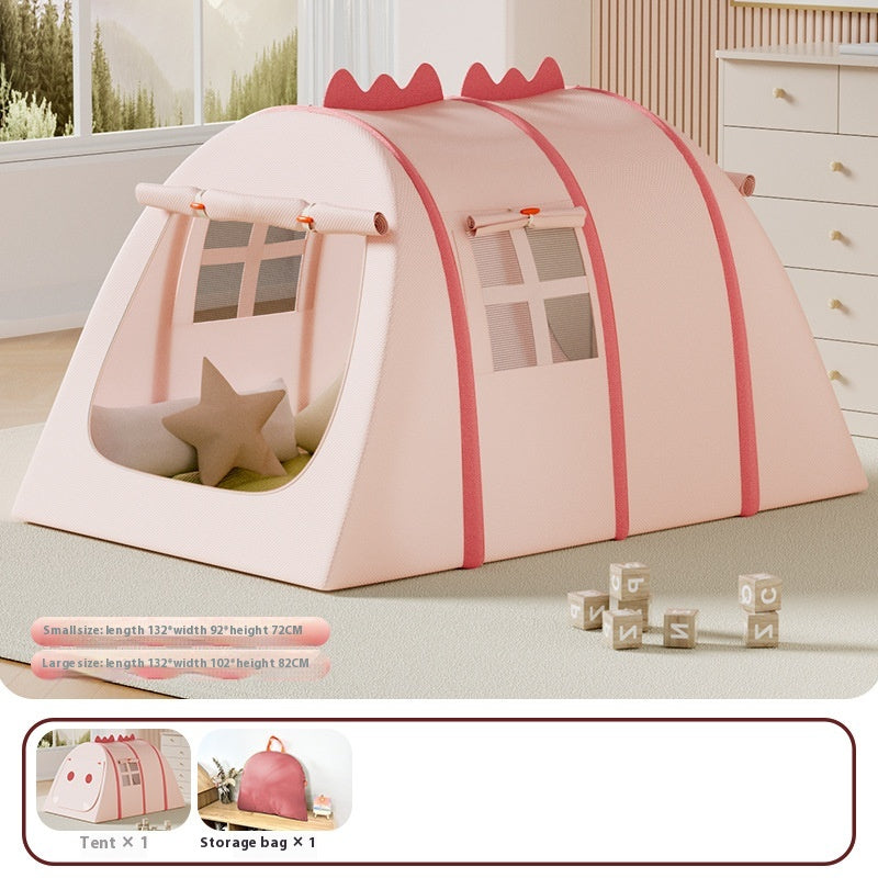Pink fabric play tent for kids, shaped like a dinosaur, with windows and a star pillow inside.
