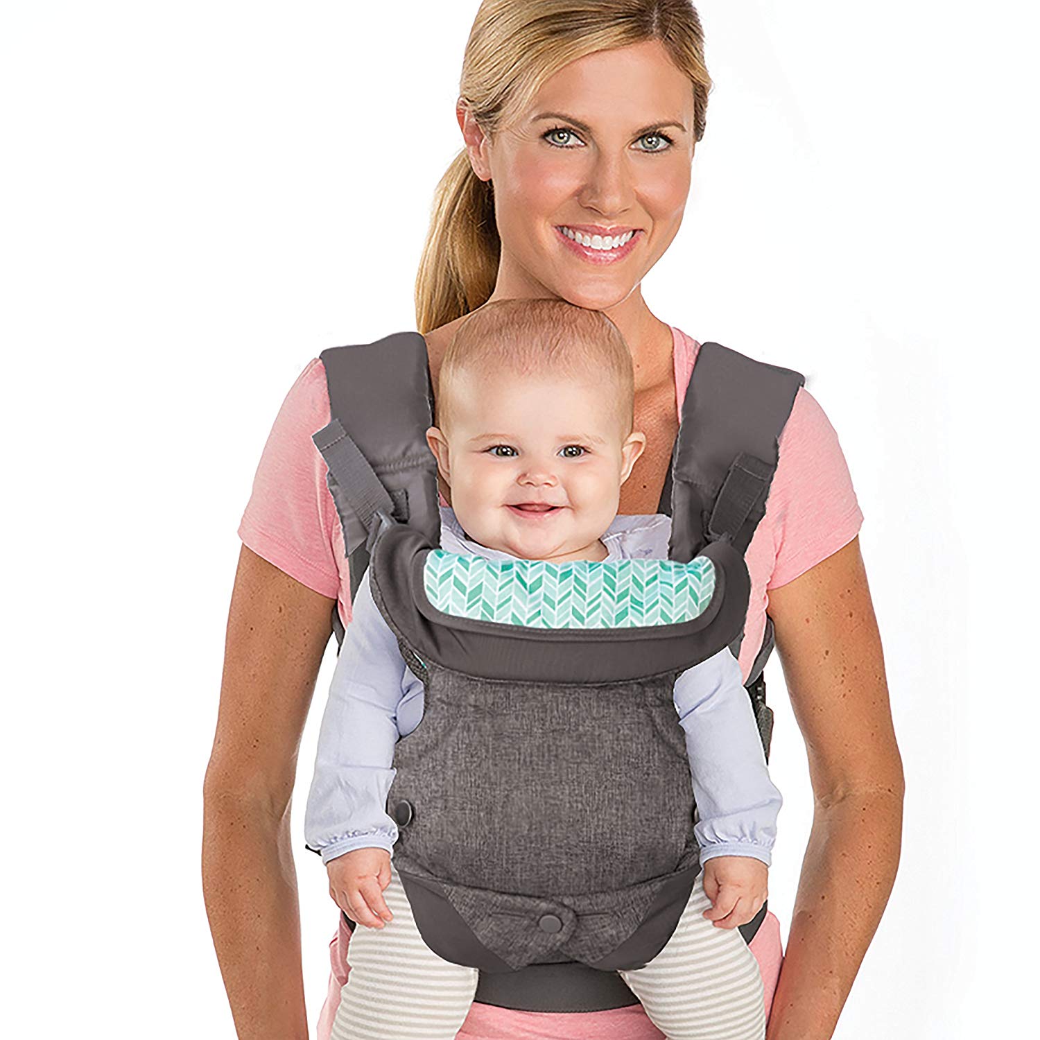 Smiling mom carries baby in a gray ergonomic carrier with a mint green patterned lining.