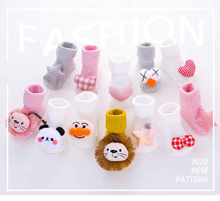 Assorted baby cotton socks with anti-slip grips, featuring cute animal and heart designs in pink, white, and gray.