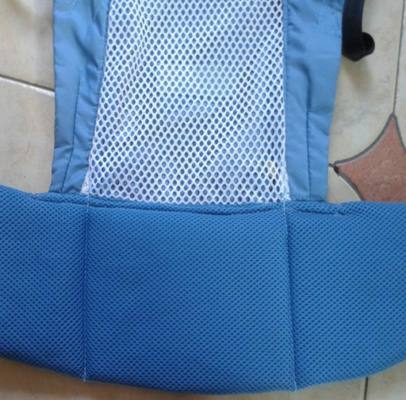Blue ergonomic baby carrier with breathable white mesh panel and padded waist support.