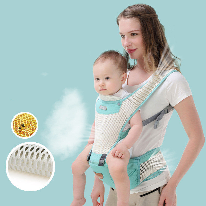 Woman carrying baby in a breathable, ergonomic mint green and white mesh hip seat carrier.