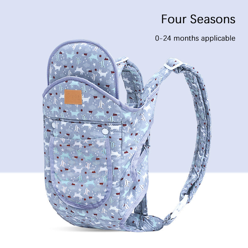 Ergonomic baby carrier in light blue with a white deer and tree pattern, suitable for 0-24 months.